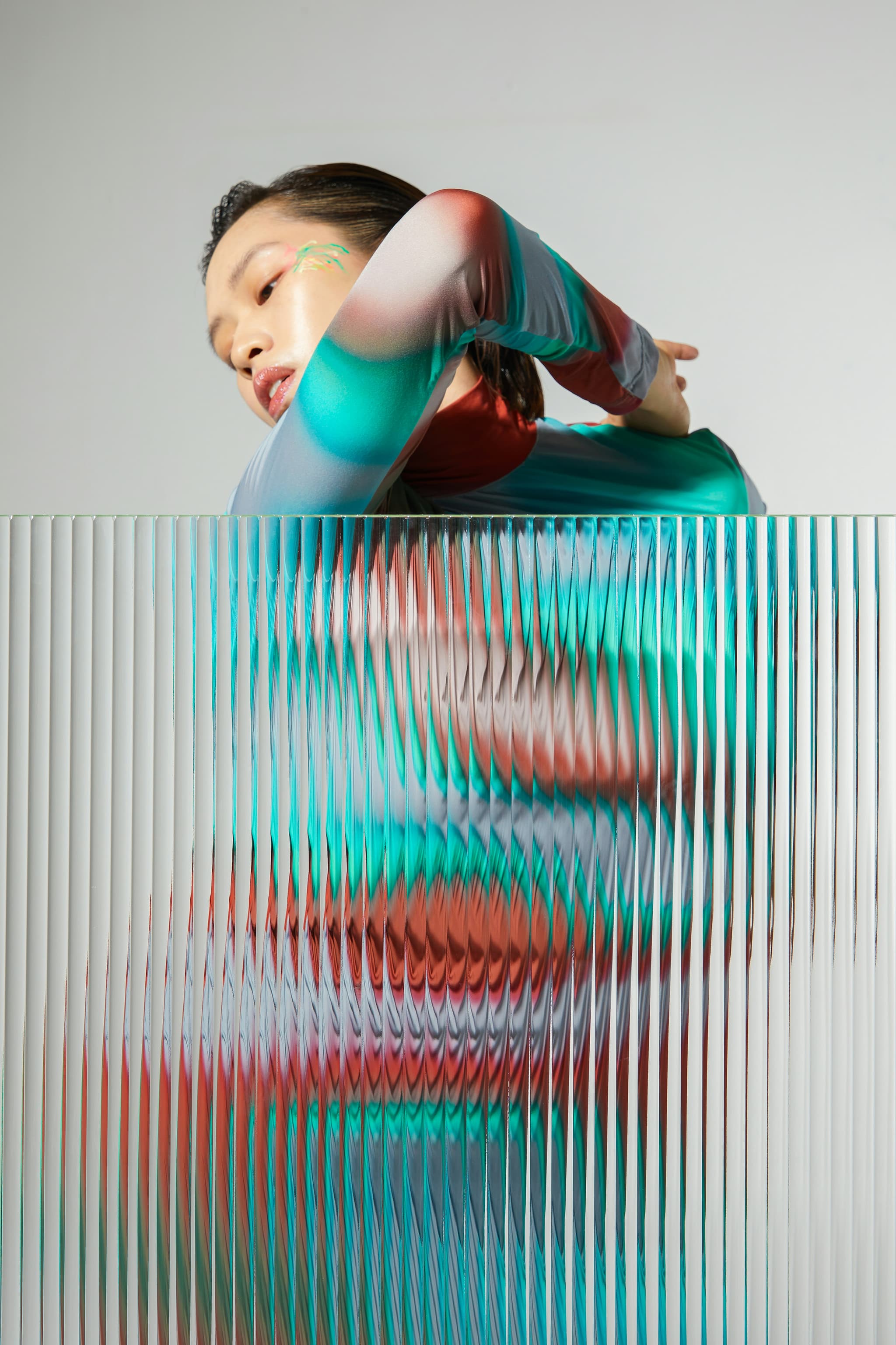 Fashion talent behind ribbed glass